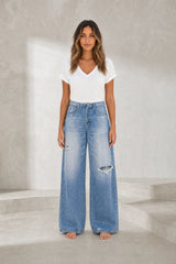 Jean bleu moyen jambe large taille repliée