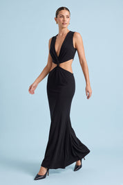 Robe longue noire à encolure asymétrique, découpes à la taille et détails dorés | Vue en mouvement | Lounelle Paris